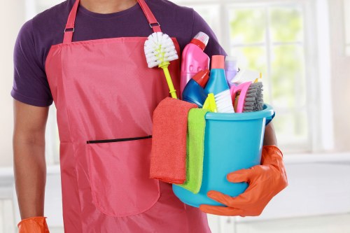 Professional carpets cleaner in SW18 treating a living room carpet
