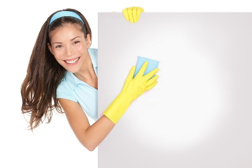 Commercial cleaner in SW18 cleaning an office workspace and floors